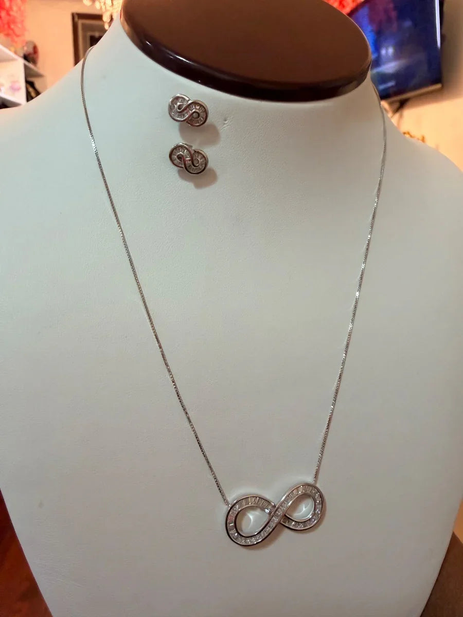 Set de collar y aretes plateados con símbolo de infinito, joyería elegante para mujer