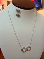 Set de collar y aretes plateados con símbolo de infinito, joyería elegante para mujer